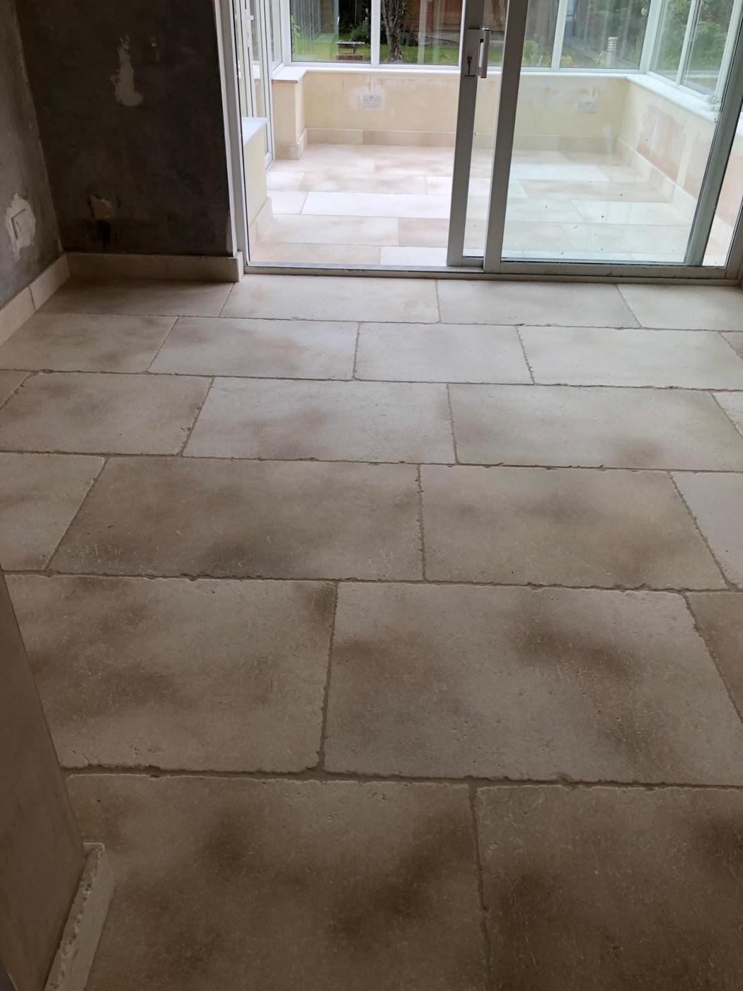 Bath Limestone showing a living room floor flowing to a consevatory floor with natural colour variations