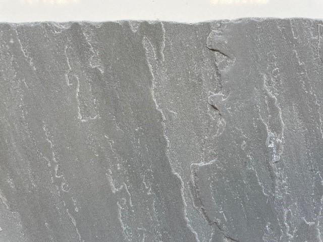 Desert Grey sandstone flooring 900x600mm tile showing light grey colour and riven surface texture