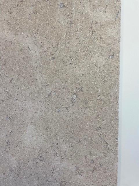 Close view of Heritage limestone flooring showing honed surface and subtle colour variation